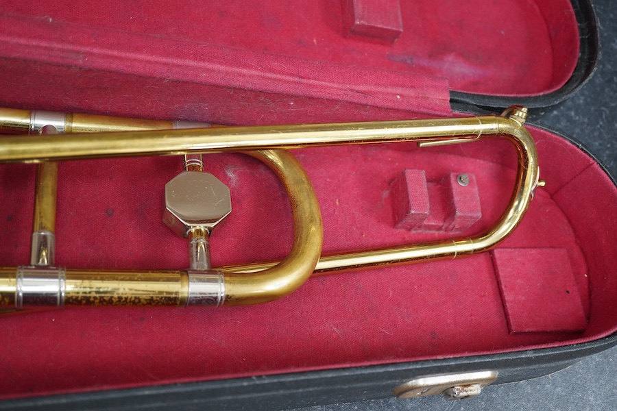 Three student trumpets by Beltone, etc. in soft cases and a cased Boosey & Hawkes trombone. Condition - poor to fair, all play